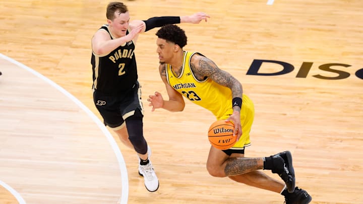 Mar 15, 2026; Chicago, IL, USA; Michigan Wolverines forward Yaxel Lendeborg (23) drives against Purdue Boilermakers guard Fletcher Loyer (2) during the second half during the men's Big Ten Conference Tournament Championship at United Center. Mandatory Credit: Kamil Krzaczynski-Imagn Images
