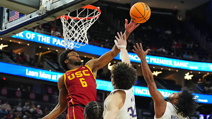 Mar 13, 2024; Las Vegas, NV, USA; USC Trojans guard Bronny James (6) deflects a rebound away from Washington Huskies center Braxton Meah (34) and guard Sahvir Wheeler (5) during the first half at T-Mobile Arena. Mandatory Credit: Stephen R. Sylvanie-USA TODAY Sports