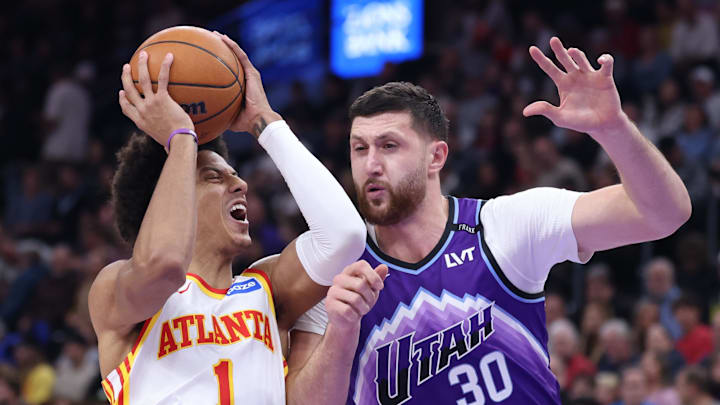 Nov 13, 2025; Salt Lake City, Utah, USA; Atlanta Hawks forward Jalen Johnson (1) drives against Utah Jazz center Jusuf Nurkic (30) during the first half at Delta Center. Mandatory Credit: Rob Gray-Imagn Images