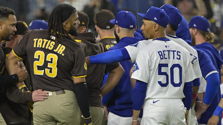 Jun 19, 2025; Los Angeles, California, USA;   San Diego Padres right fielder Fernando Tatis Jr. (23) and Los Angeles Dodgers shortstop Mookie Betts (50) engage on the field after benches cleared in the eighth inning at Dodger Stadium. Mandatory Credit: Jayne Kamin-Oncea-Imagn Images