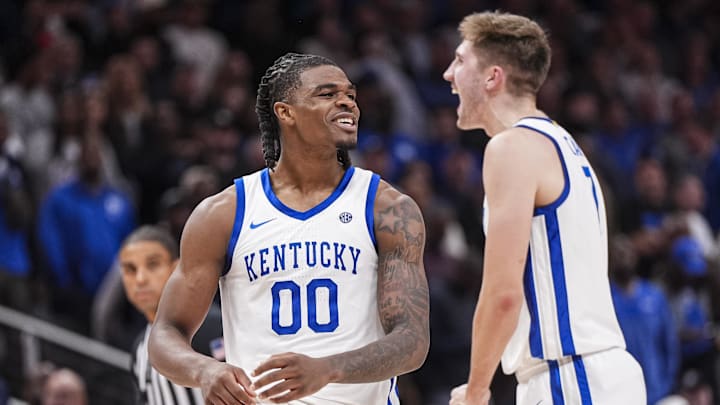 Nov 12, 2024; Atlanta, Georgia, USA; Kentucky Wildcats guard Otega Oweh (00) reacts with forward Andrew Carr (7) against the Duke Blue Devils during the second half at State Farm Arena. Mandatory Credit: Dale Zanine-Imagn Images