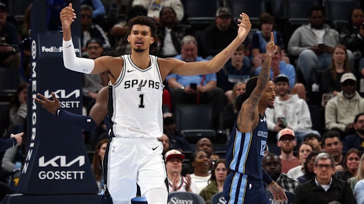 Feb 3, 2025; Memphis, Tennessee, USA; San Antonio Spurs center Victor Wembanyama (1) and Memphis Grizzlies guard Ja Morant (12) react during the first quarter at FedExForum. Mandatory Credit: Petre Thomas-Imagn Images