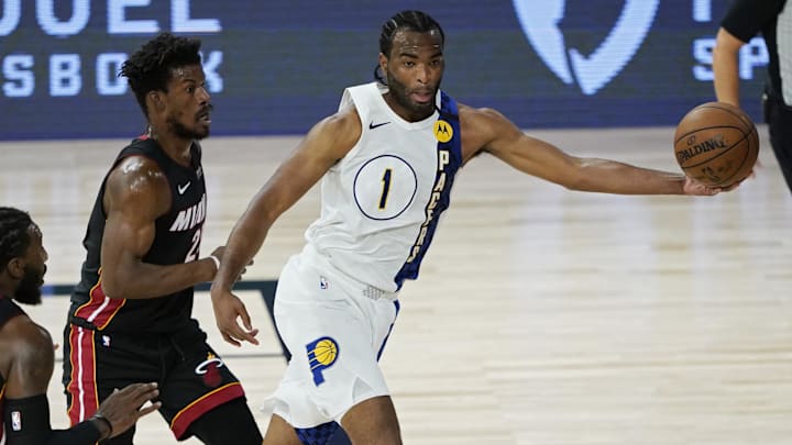 Aug 24, 2020; Lake Buena Vista, Florida, USA; Indiana Pacers' T.J. Warren (1) passes around Miami Heat's Jimmy Butler (22) during the second half in game four of the first round of the 2020 NBA Playoffs at The Field House. Mandatory Credit: Ashley Landis/Pool Photo-Imagn Images