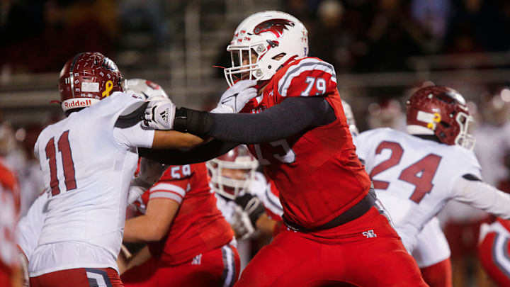 Nixa Eagles Jackson Cantwell holds back a Joplin defender during the championship game of Class 6 District 5 football at Nixa on Friday, Nov. 11, 2023.