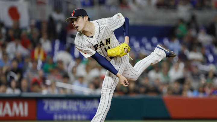Mar 20, 2023; Miami, Florida, USA; Japan starting pitcher Roki Sasaki (14) delivers a pitch during the first inning against Mexico at LoanDepot Park. Mandatory Credit: Sam Navarro-Imagn Images