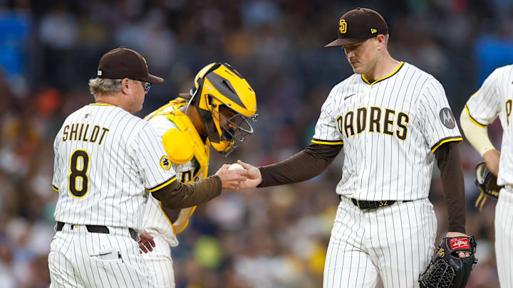 Jul 5, 2025; San Diego, California, USA; San Diego Padres manager Mike Shildt (8) takes the ball from starting pitcher Stephen Kolek (32) during a sixth inning pitching change against the Texas Rangers at Petco Park. Mandatory Credit: David Frerker-Imagn Images