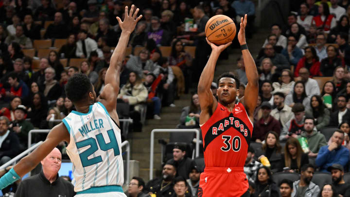 Mar 3, 2024; Toronto, Ontario, CAN;  Toronto Raptors guard Ochai Agbaji (30) shoots the ball as Charlotte Hornets forward Brandon Miller (24) defends in the first half at Scotiabank Arena. Mandatory Credit: Dan Hamilton-USA TODAY Sports