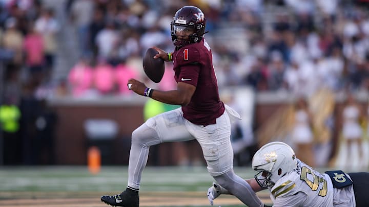 Oct 11, 2025; Atlanta, Ga. Virginia Tech quarterback Kyron Drones (1) runs past Georgia Tech defensive tackle Jordan van den Berg (99).