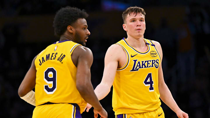 Mar 20, 2025; Los Angeles, California, USA; Los Angeles Lakers guard Dalton Knecht (4) fives guard Bronny James (9) after scoring against the Milwaukee Bucks during the second half at Crypto.com Arena. Mandatory Credit: Jonathan Hui-Imagn Images