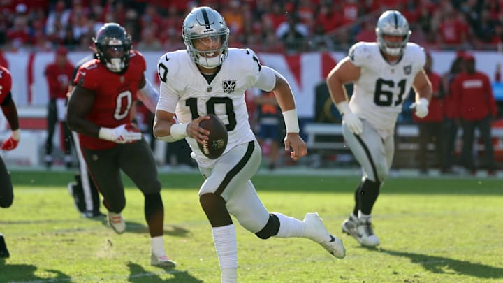 Dec 8, 2024; Tampa, Florida, USA; Las Vegas Raiders quarterback Desmond Ridder (10) runs with the ball against the Tampa Bay Buccaneers during the second half at Raymond James Stadium. Mandatory Credit: Kim Klement Neitzel-Imagn Images