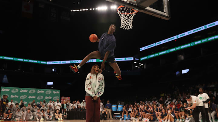 Mar 31, 2025; Brooklyn, New York, USA; McDonald’s All American West forward AJ Dybantsa (3) dunks the ball over  Chicago Sky forward Angel Reese during the Sprite Jam Fest at Barclay's Center. Mandatory Credit: Pamela Smith-Imagn Images