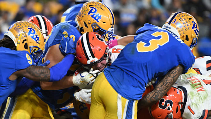Oct 24, 2024; Pittsburgh, Pennsylvania, USA; Syracuse Orange quarterback Kyle McCord (6) scores a touchdown against Pittsburgh Panthers linebacker Brandon George (30) during the third quarter at Acrisure Stadium. Mandatory Credit: Barry Reeger-Imagn Images Oct 24, 2024; Pittsburgh, Pennsylvania, USA; Syracuse Orange quarterback Kyle McCord (6) scores a touchdown against Pittsburgh Panthers linebacker Brandon George (30) during the third quarter at Acrisure Stadium. Mandatory Credit: Barry Reeger-Imagn Images