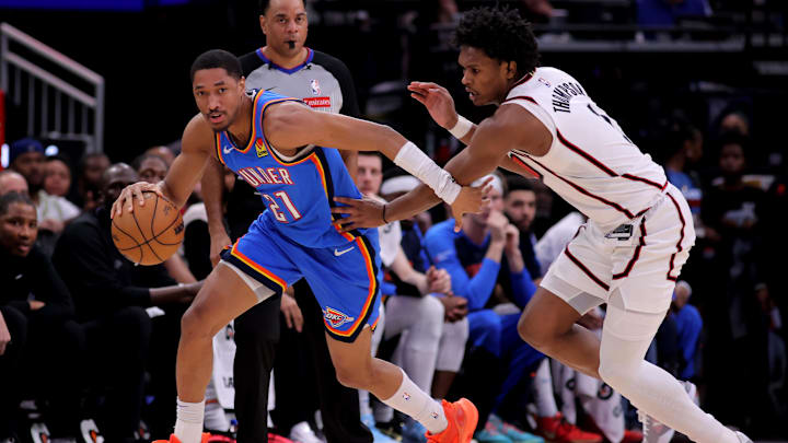 Apr 4, 2025; Houston, Texas, USA; Oklahoma City Thunder guard Aaron Wiggins (21) handles the ball against Houston Rockets guard Amen Thompson (1) during the third quarter at Toyota Center. Mandatory Credit: Erik Williams-Imagn Images