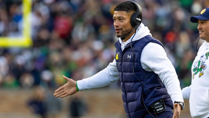 Nov 22, 2025; South Bend, Indiana, USA; Notre Dame Fighting Irish head coach Marcus Freeman celebrates with players after scoring against the Syracuse Orange during the first half at Notre Dame Stadium. 