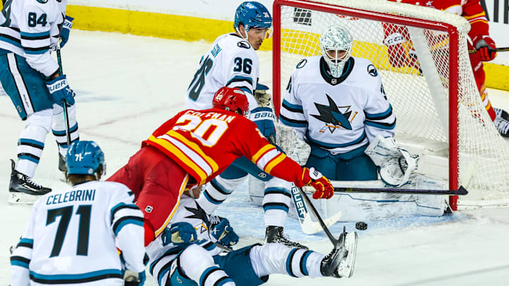 Apr 13, 2025; Calgary, Alberta, CAN; San Jose Sharks goaltender Georgi Romanov (31) makes a save against Calgary Flames left wing Blake Coleman (20) during the second period at Scotiabank Saddledome. Mandatory Credit: Sergei Belski-Imagn Images