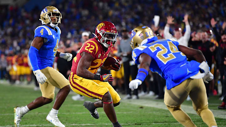 Nov 19, 2022; Pasadena, California, USA; Southern California Trojans running back Darwin Barlow (22) runs the ball for a touchdown againt defensive back Jaylin Davies (24) during the second half at the Rose Bowl. Mandatory Credit: Gary A. Vasquez-Imagn Images Nov 19, 2022; Pasadena, California, USA; Southern California Trojans running back Darwin Barlow (22) runs the ball for a touchdown againt defensive back Jaylin Davies (24) during the second half at the Rose Bowl. Mandatory Credit: Gary A. Vasquez-Imagn Images