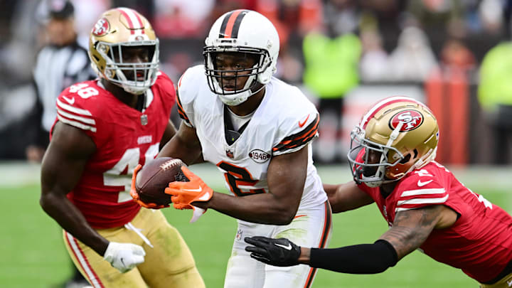 Oct 15, 2023; Cleveland, Ohio, USA; Cleveland Browns wide receiver Amari Cooper (2) runs with the ball after a catch as San Francisco 49ers cornerback Deommodore Lenoir (2) and linebacker Oren Burks (48) defend during the second half at Cleveland Browns Stadium.