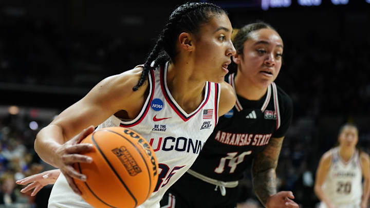 Mar 22, 2025; Storrs, Connecticut, USA; UConn Huskies guard Azzi Fudd (35) drives the ball against Arkansas State Red Wolves guard Anna Griffin (14) in the first half at Harry A. Gampel Pavilion. Mandatory Credit: David Butler II-Imagn Images