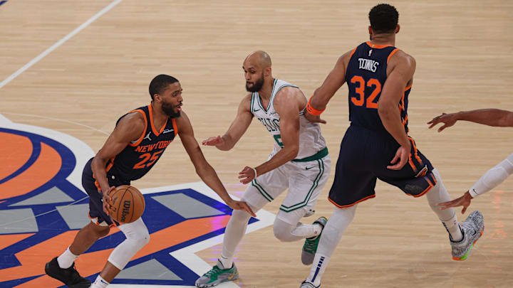 May 12, 2025; New York, New York, USA; New York Knicks forward Mikal Bridges (25) dribbles as Boston Celtics guard Derrick White (9) fights through a screen by New York Knicks center Karl-Anthony Towns (32) in the first half during game four of the second round for the 2025 NBA Playoffs at Madison Square Garden. Mandatory Credit: Vincent Carchietta-Imagn Images