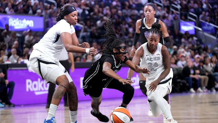 Aug 6, 2025; San Francisco, California, USA; Golden State Valkyries guard Tiffany Hayes (15) is fouled while driving to the hoop between Las Vegas Aces forward NaLyssa Smith (3) and guard Jewell Loyd (24) in the fourth quarter at the Chase Center. Mandatory Credit: Cary Edmondson-Imagn Images