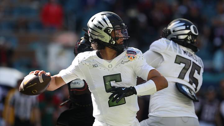 Jan 1, 2026; Miami Gardens, FL, USA; Oregon Ducks quarterback Dante Moore (5) throws the ball against the Texas Tech Red Raiders during the first half of the 2025 Orange Bowl and quarterfinal game of the College Football Playoff at Hard Rock Stadium. Mandatory Credit: Nathan Ray Seebeck-Imagn Images