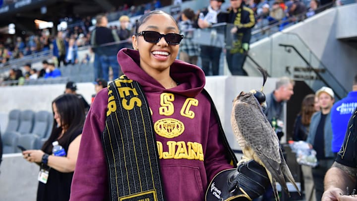 USC women's basketball star JuJu Watkins smiles with the LAFC falcon before a MLS game against the New York Red Bulls.