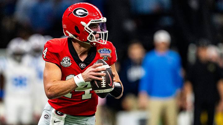 Georgia quarterback Gunner Stockton (14) rolls out of the pocket during the Sugar Bowl and College Football Playoff quarterfinals at Caesars Superdome in New Orleans, La., on Thursday, Jan. 1, 2026. Ole Miss defeated Georgia 39-34.
