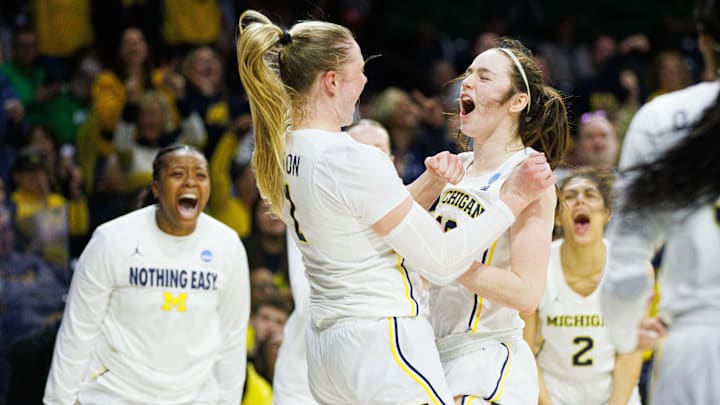 Michigan guard Olivia Olson (1) and guard Syla Swords, right, celebrate Olson scoring a basket and drawing a foul during the first round of the NCAA Women's Basketball Tournament between Michigan and Iowa State at Purcell Pavilion on Friday, March 21, 2025, in South Bend.