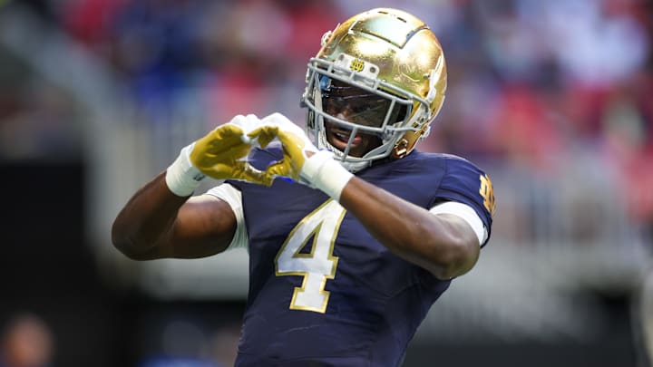 Oct 19, 2024; Atlanta, Georgia, USA; Notre Dame Fighting Irish running back Jeremiyah Love (4) celebrates after a touchdown against the Georgia Tech Yellow Jackets in the third quarter at Mercedes-Benz Stadium. Mandatory Credit: Brett Davis-Imagn Images

