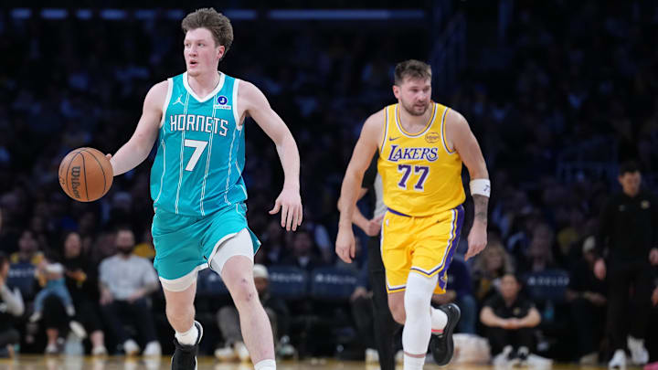 Jan 15, 2026; Los Angeles, California, USA; Charlotte Hornets guard Kon Knueppel (7) dribbles the ball against Los Angeles Lakers guard Luka Doncic (77) in the second half at Crypto.com Arena.