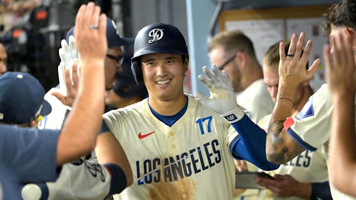 Sep 20, 2025; Los Angeles, California, USA;  Los Angeles Dodgers designated hitter Shohei Ohtani (17) is congratulated in the dugout after hitting a solo home run in the fifth inning against the San Francisco Giants at Dodger Stadium. Mandatory Credit: Jayne Kamin-Oncea-Imagn Images