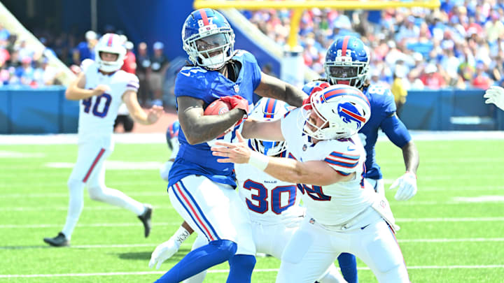 Aug 9, 2025; Orchard Park, New York, USA; New York Giants wide receiver Ihmir Smith-Marsette (87) is tackled by Buffalo Bills long snapper Reid Ferguson (69) in the second quarter at Highmark Stadium. Mandatory Credit: Mark Konezny-Imagn Images