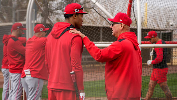 Cincinnati Reds manager Terry Francona chats with outfielder Will Benson (30) at the Cincinnati Reds Player Development Complex in Goodyear, Ariz., on Wednesday, Feb. 12, 2025.