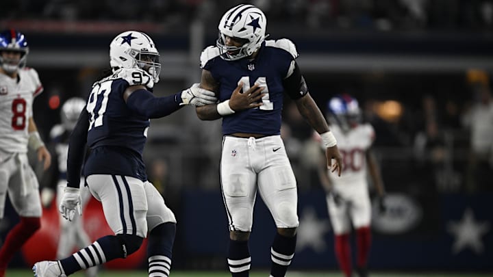 Dallas Cowboys linebacker Micah Parsons and defensive tackle Osa Odighizuwa celebrate after Parsons sacks New York Giants quarterback Daniel Jones.