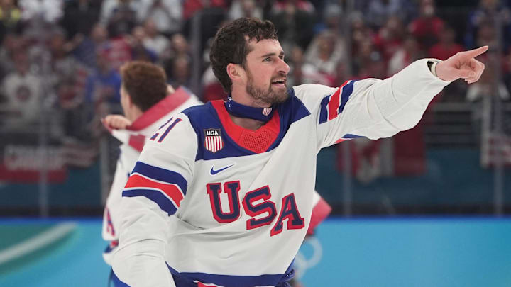 Feb 22, 2026; Milan, Italy; Dylan Larkin (21) of the United States celebrates after defeating Canada in the men's ice hockey gold medal game during the Milano Cortina 2026 Olympic Winter Games at Milano Santagiulia Ice Hockey Arena. Mandatory Credit: Amber Searls-Imagn Images