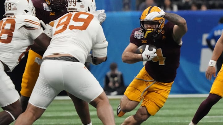 Arizona State running back Cam Skattebo (4) cuts past Texas defensive lineman Jermayne Lole (99) during the Chick-fil-A Peach Bowl on Jan 1, 2025, in Atlanta, Ga.
