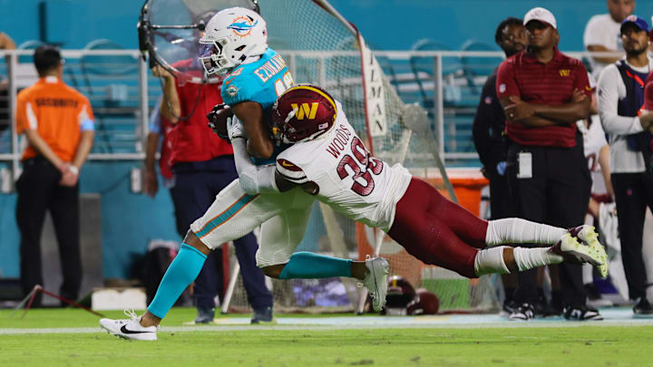Miami Dolphins wide receiver Erik Ezukanma (18) catches the football against Washington Commanders cornerback A.J. Woods (38) during the third quarter of a preseason game at Hard Rock Stadium in the 2024 preseason. Miami Dolphins wide receiver Erik Ezukanma (18) catches the football against Washington Commanders cornerback A.J. Woods (38) during the third quarter of a preseason game at Hard Rock Stadium in the 2024 preseason.