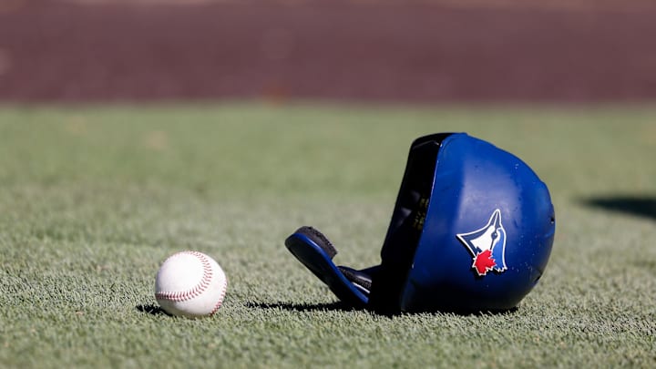 Mar 17, 2022; Dunedin, FL, USA;  Toronto Blue Jays batting helmet lays on the ground during workouts at Toronto Blue Jays Player Development Complex. Mandatory Credit: Nathan Ray Seebeck-Imagn Images