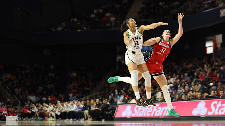 Apr 25, 2026; Washington, DC, USA: Washington Mystics forward Angela Dugalic (32) is fouled while shooting by Minnesota Lynx forward Nia Coffey (12) in the first half at Entertainment & Sports Arena. Mandatory Credit: Geoff Burke-Imagn Images