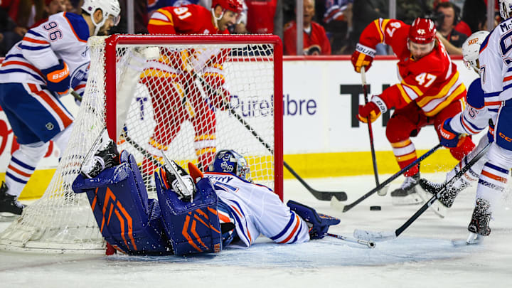 Feb 4, 2026; Calgary, Alberta, CAN; Edmonton Oilers goaltender Tristan Jarry (35) guards his net against Calgary Flames center Connor Zary (47) during the second period at Scotiabank Saddledome. Mandatory Credit: Sergei Belski-Imagn Images