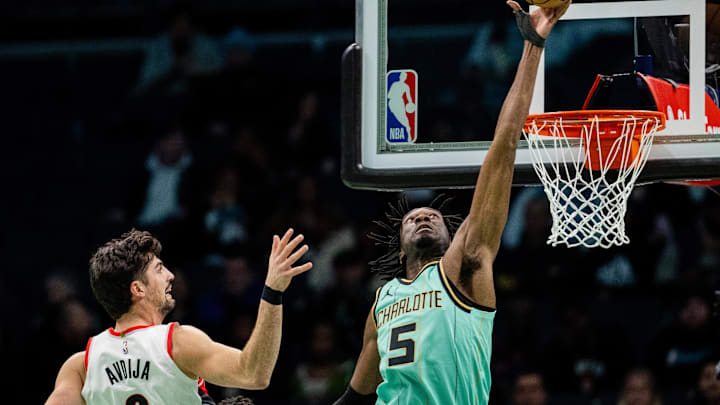 Jan 24, 2025; Charlotte, North Carolina, USA; Charlotte Hornets center Mark Williams (5) blocks the shot from Portland Trail Blazers forward Deni Avdija (8) during the second quarter at Spectrum Center. Mandatory Credit: Scott Kinser-Imagn Images
