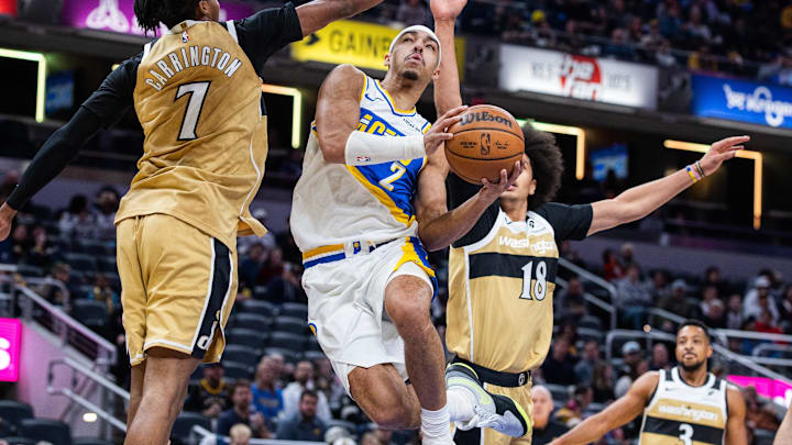 Dec 14, 2025; Indianapolis, Indiana, USA;  Indiana Pacers guard/forward Andrew Nembhard (2) shoots the ball while  Washington Wizards guard Bub Carrington (7) and forward Kyshawn George (18) defend in the first half at Gainbridge Fieldhouse. Mandatory Credit: Trevor Ruszkowski-Imagn Images