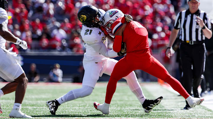 Oct 19, 2024; Tucson, Arizona, USA; Colorado Buffaloes safety Shilo Sanders (21) tackles Arizona Wildcats wide receiver Jeremiah Patterson (2) during the first quarter at Arizona Stadium. Oct 19, 2024; Tucson, Arizona, USA; Colorado Buffaloes safety Shilo Sanders (21) tackles Arizona Wildcats wide receiver Jeremiah Patterson (2) during the first quarter at Arizona Stadium.