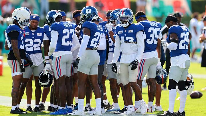 Aug 20, 2026; Miami Gardens, FL, USA; New York Giants cornerback Paulson Adebo (21), cornerback Art Green (23), and safety Raheem Layne (43) work during joint practice with the Miami Dolphins at Baptist Health Training Complex.  