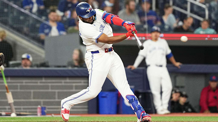 Sep 27, 2024; Toronto, Ontario, CAN; Toronto Blue Jays first baseman Vladimir Guerrero Jr. (27) hits a single against the Miami Marlins during the eighth inning at Rogers Centre. Mandatory Credit: Nick Turchiaro-Imagn Images