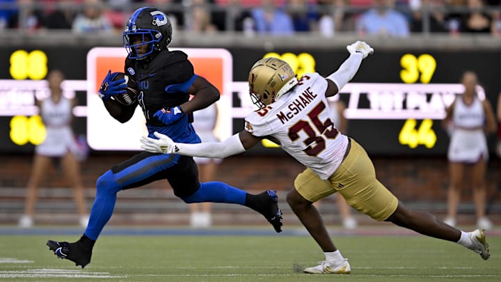 Nov 16, 2024; Dallas, Texas, USA; SMU Mustangs running back Brashard Smith (1) and Boston College Eagles defensive back Ashton McShane (35) in action during the game between the SMU Mustangs and the Boston College Eagles at Gerald J. Ford Stadium. Mandatory Credit: Jerome Miron-Imagn Images