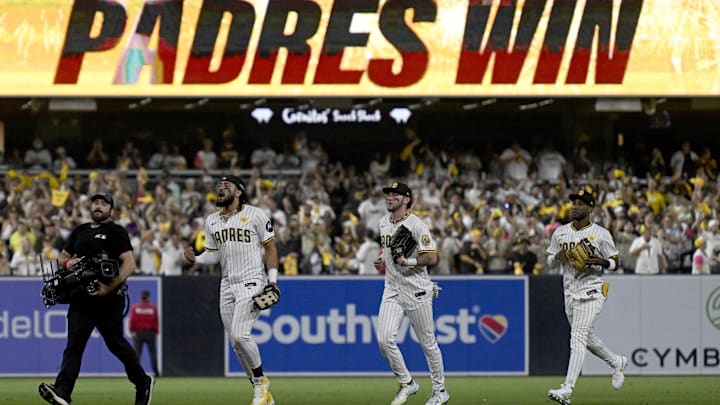 Oct 8, 2024; San Diego, California, USA; San Diego Padres outfielder Fernando Tatis Jr. (23), left, outfielder Jackson Merrill (3) and outfielder Jurickson Profar (10), right, celebrate after defeating the Los Angeles Dodgers during game three of the NLDS for the 2024 MLB Playoffs at Petco Park.  Mandatory Credit: Denis Poroy-Imagn Images