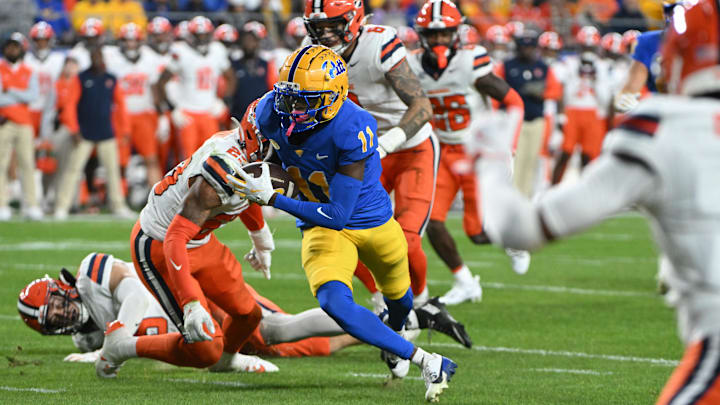 Oct 24, 2024; Pittsburgh, Pennsylvania, USA; Pittsburgh Panthers wide receiver Censere Lee (11) eludes Syracuse Orange defenders on a touchdown during the second quarter at Acrisure Stadium. Mandatory Credit: Barry Reeger-Imagn Images