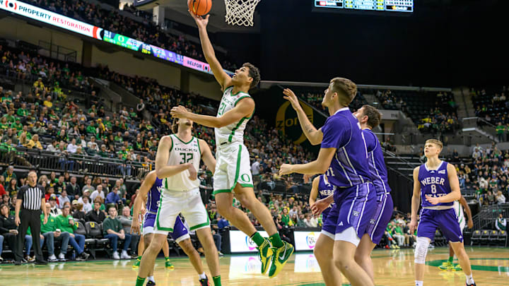 Dec 29, 2024; Eugene, Oregon, USA; Oregon Ducks forward Brandon Angel (21) scores a layup basket against the Weber State Wildcats during the second half at Matthew Knight Arena.