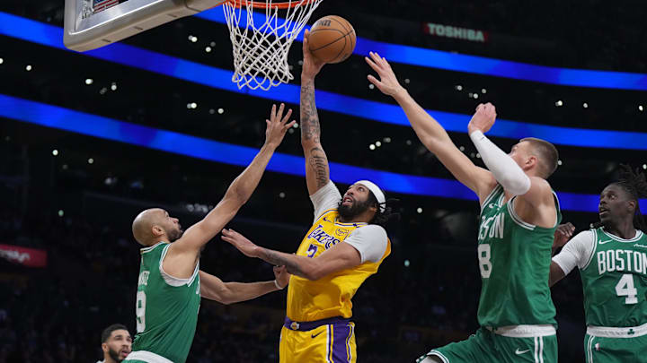 Jan 23, 2025; Los Angeles, California, USA: Los Angeles Lakers center Anthony Davis (3) shoots the ball against Boston Celtics center Kristaps Porzingis (8) and guard Derrick White (9) in the second half at the Crypto.com Arena. Mandatory Credit: Kirby Lee-Imagn Images Jan 23, 2025; Los Angeles, California, USA: Los Angeles Lakers center Anthony Davis (3) shoots the ball against Boston Celtics center Kristaps Porzingis (8) and guard Derrick White (9) in the second half at the Crypto.com Arena. Mandatory Credit: Kirby Lee-Imagn Images